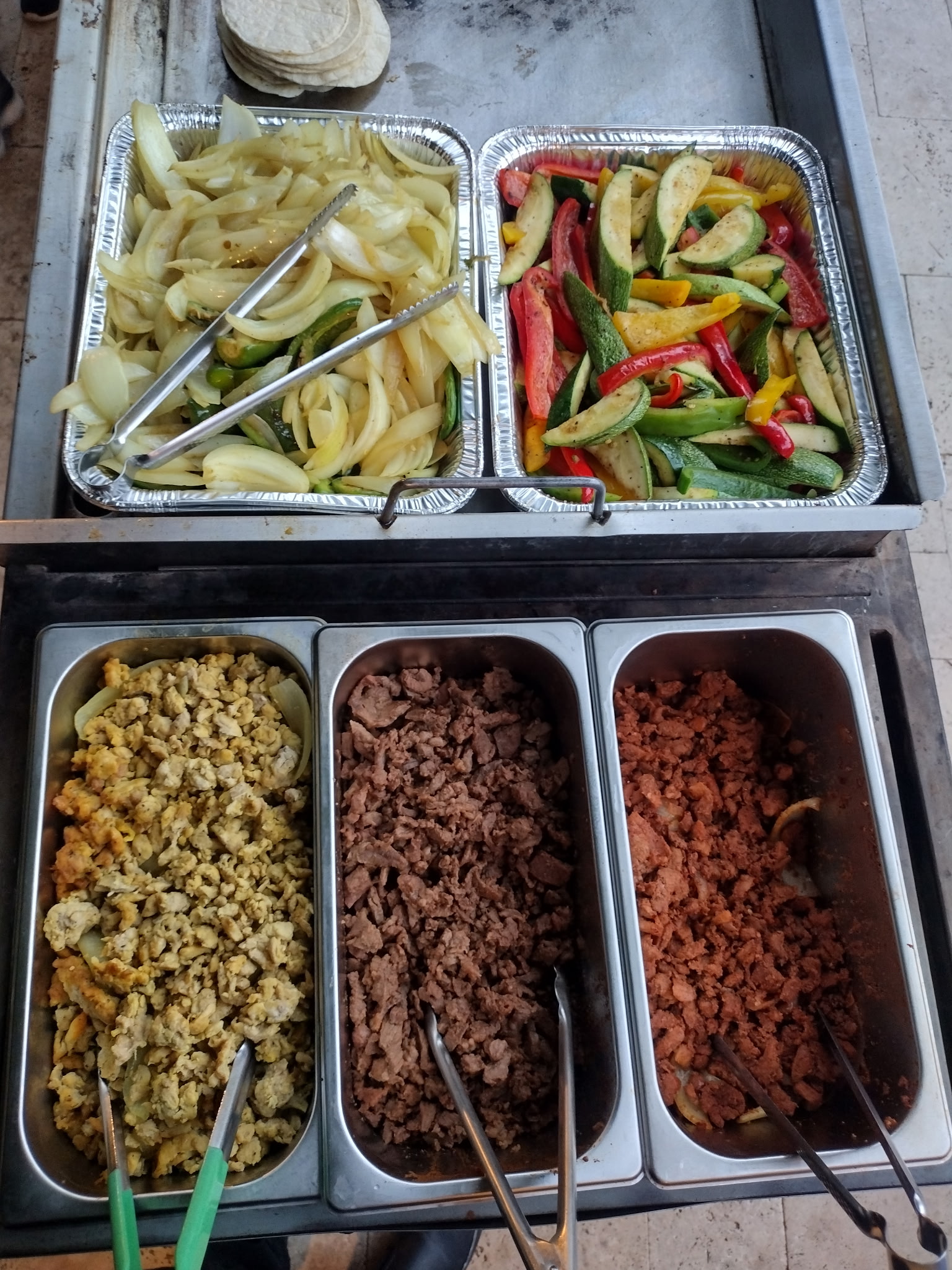 Taco meats and vegetables prepared for an event