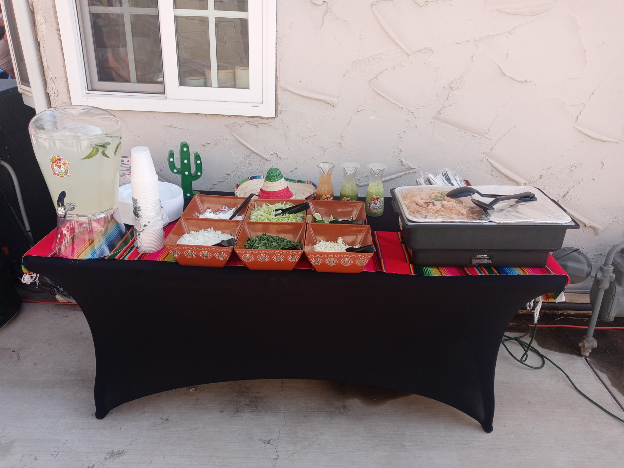 Fresh taco toppings arranged at a catering station